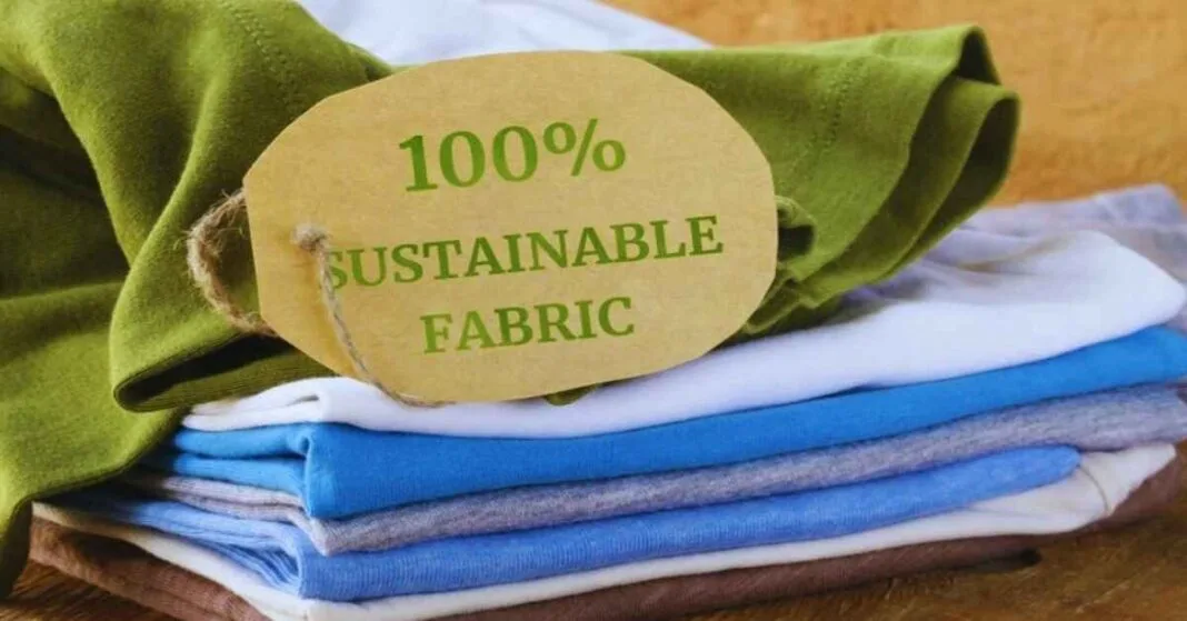 A stack of colorful sustainable fabrics with a tag reading 