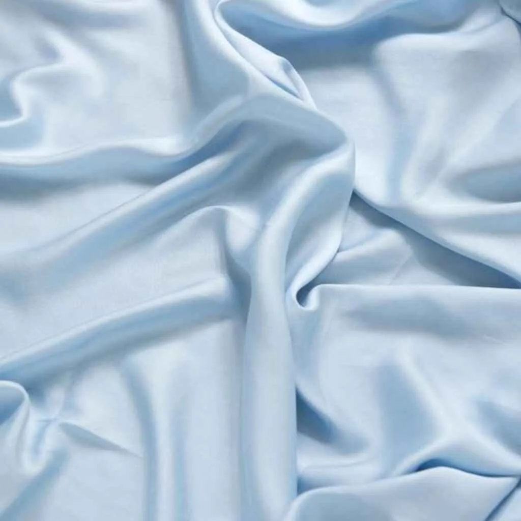 Soft light blue Tencel (Lyocell) fabric draped to show its smooth and luxurious texture.