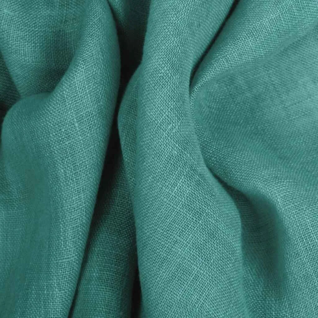 Close-up of soft, teal linen fabric showcasing its lightweight and breathable texture.