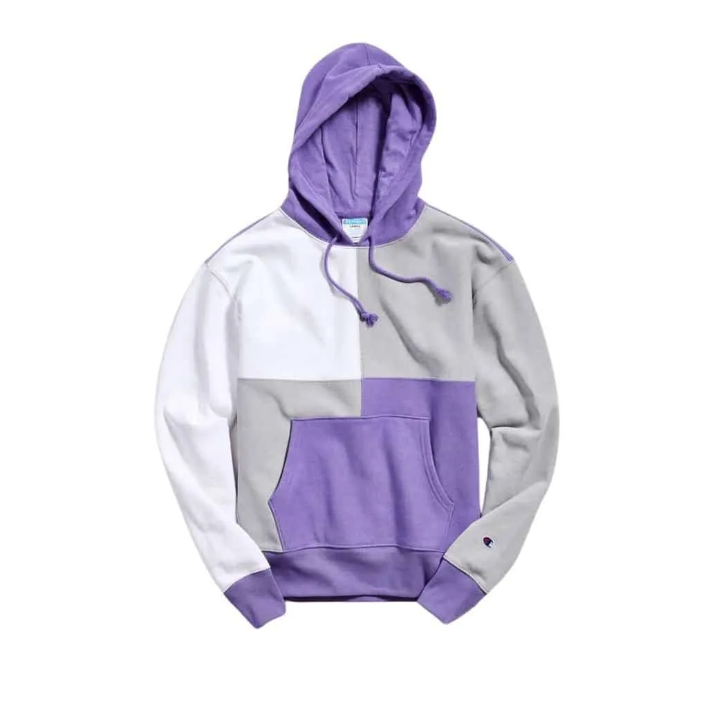 Color-blocked hoodie in purple, gray, and white, featuring a drawstring hood and a front pocket.