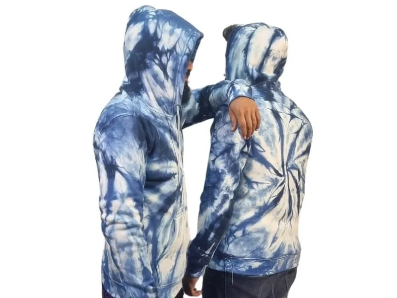 Two individuals wearing blue tie-dye hoodies, one with their back turned and the other facing slightly forward, showcasing the design.