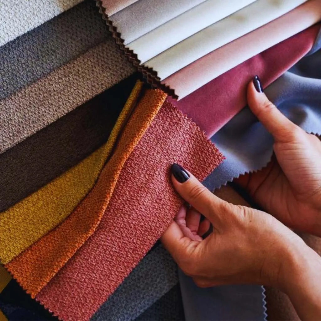 Aesthetic linen fabric swatches highlighting color and texture variations. Hands holding various samples of linen fabric in a colorful display.