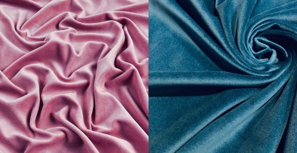 Close-up view of pink and blue velour fabric showcasing soft texture and folds.