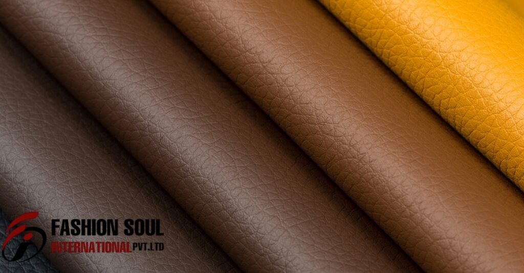 Four rolls of faux leather in varying shades, including dark brown, light brown, medium brown, and yellow, displayed side by side.