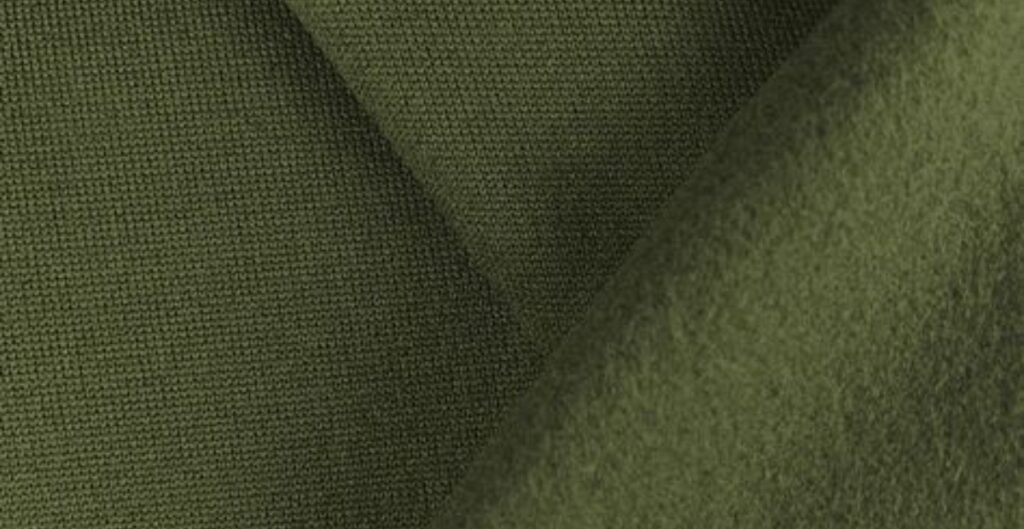 Close-up view of green fleece fabric showing its texture and weave.