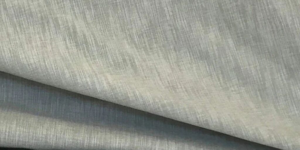 A close-up of luxurious Shantung fabric with a silky texture and elegant sheen, perfect for high-fashion garments and accessories.