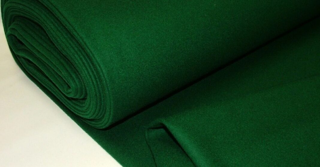 Green baize fabric roll, known for its soft, durable, and slightly fuzzy texture, commonly used in gaming tables and upholstery.