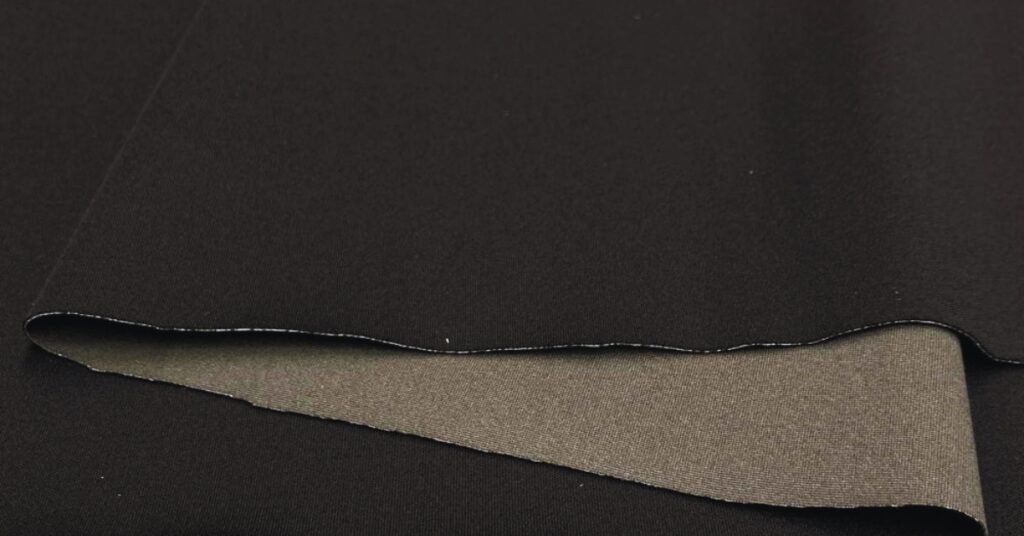 Close-up view of NeoShell fabric showcasing its breathable, waterproof, and flexible properties for outdoor wear.