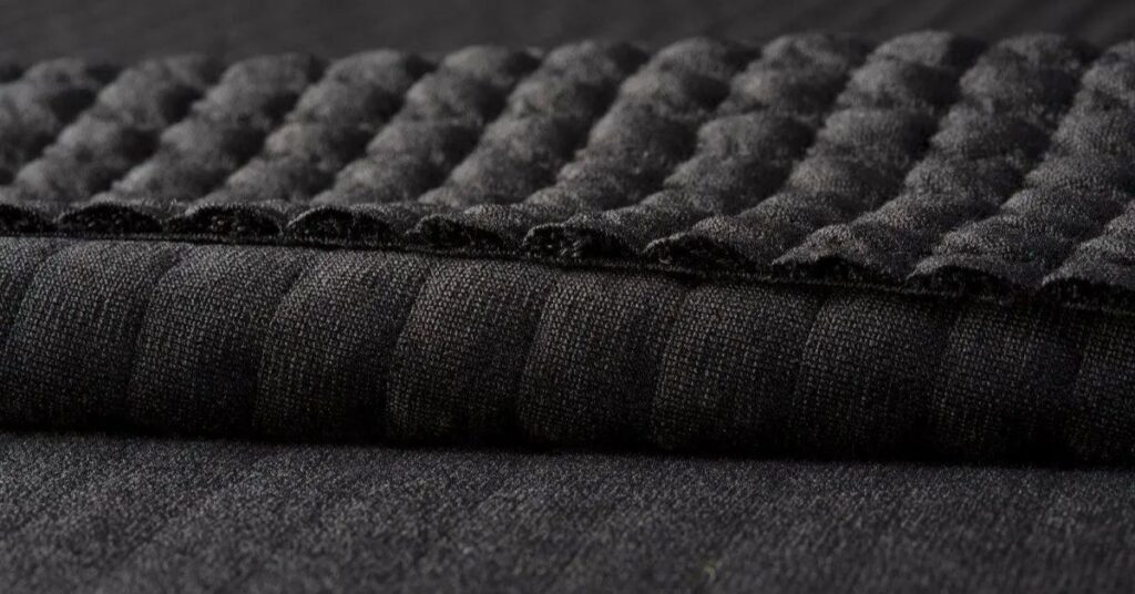 Close-up view of Polartec fabric showing its quilted texture, soft insulation, and high-performance warmth.