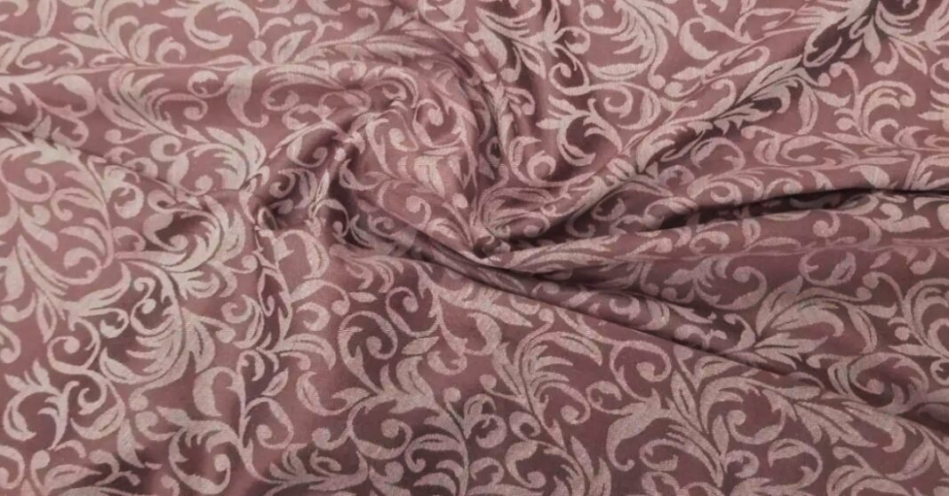 Elegant jacquard fabric with intricate woven patterns, showcasing a luxurious and stylish texture.