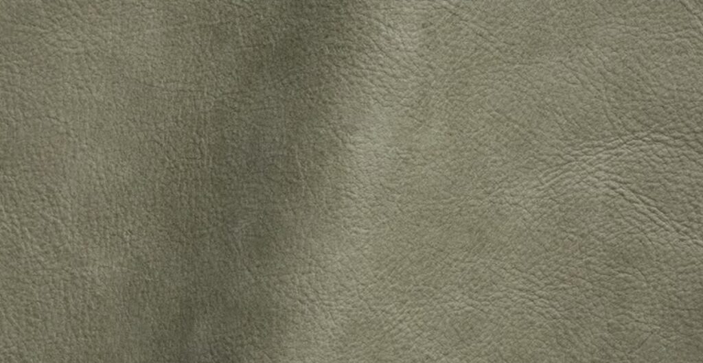 Close-up of textured olive green nubuck leather.