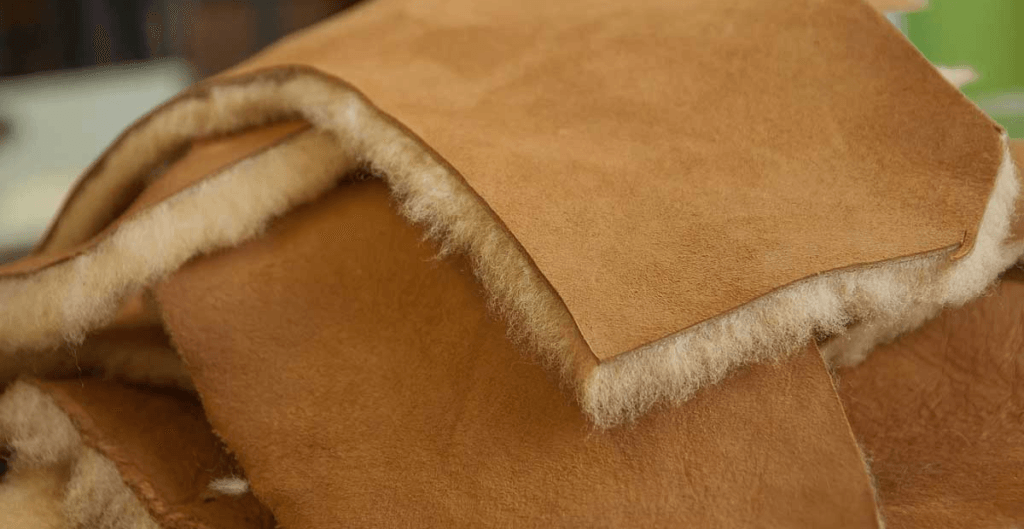 A close-up of soft shearling leather showing its plush texture.