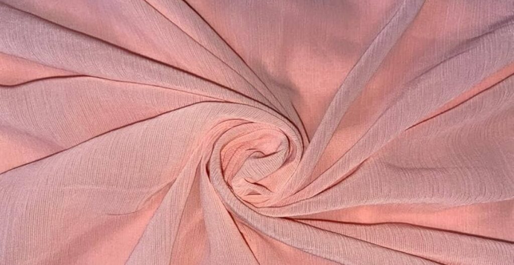 Close-up view of lightweight georgette fabric in soft folds, showcasing its sheer and crinkled texture.