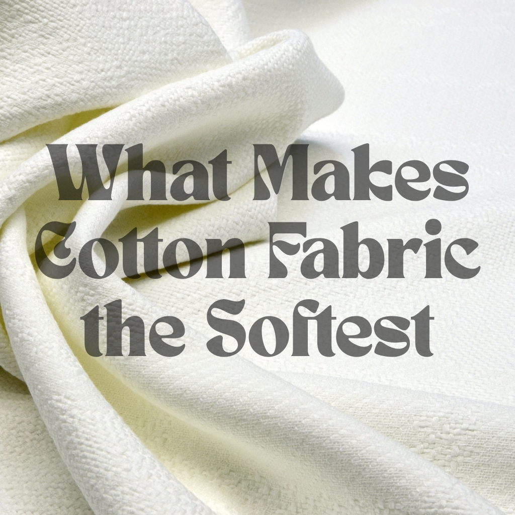 A close-up shot of soft, white cotton fabric with the text "What Makes Cotton Fabric the Softest" written in bold, dark gray letters over it.