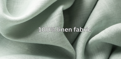 Close-up of a soft, green linen fabric with wrinkled texture.