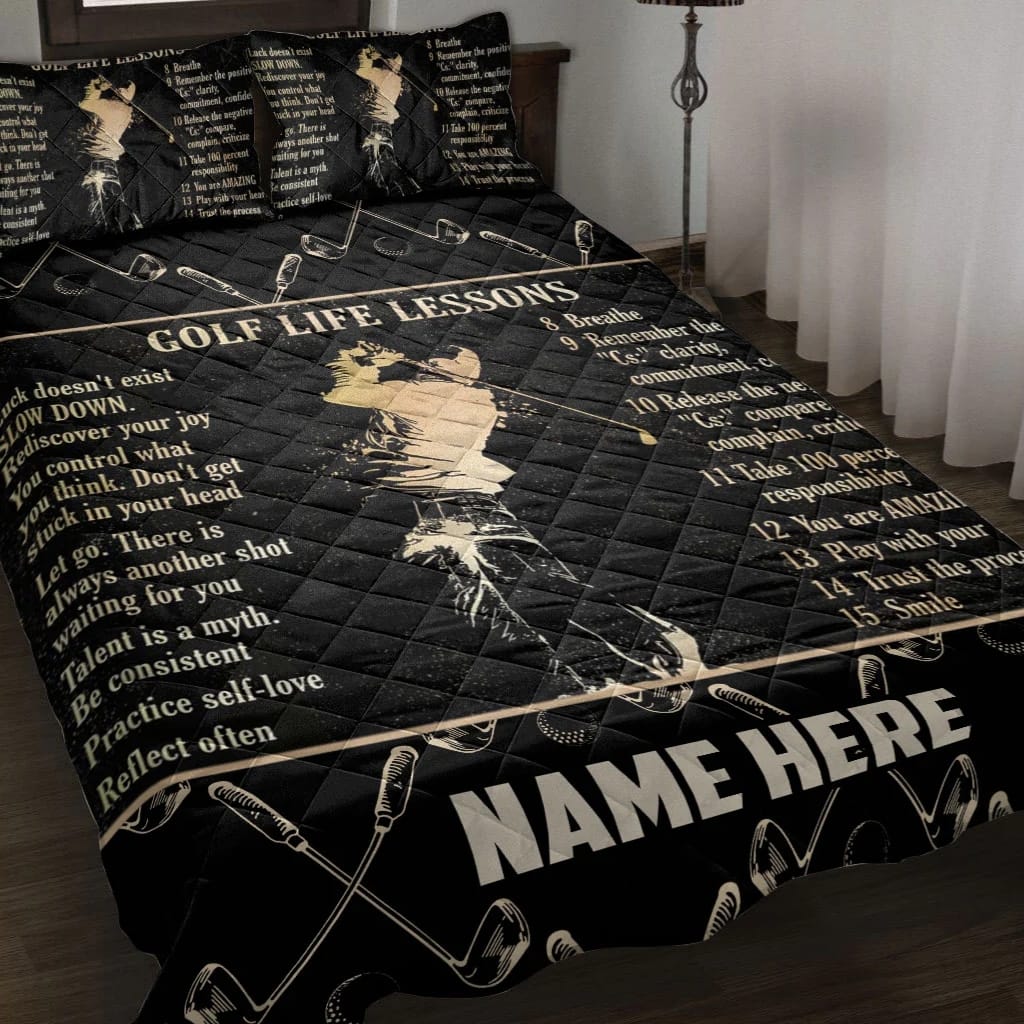 A bed covered with a black bedspread featuring "Golf Life Lessons" written across the top, along with a list of tips, a stylized golfer image in the center, and golf club illustrations at the bottom.