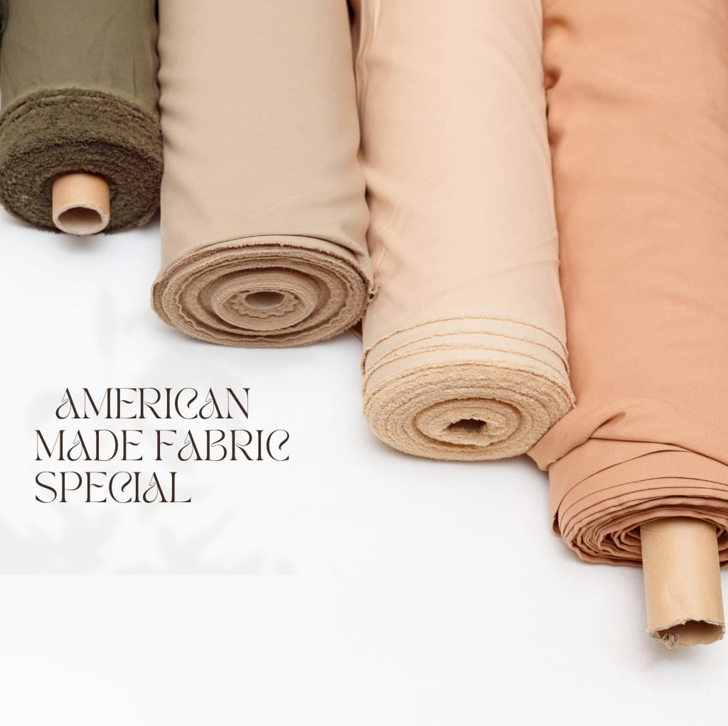 Four neatly rolled fabric bolts in earthy tones (olive green, beige, light tan, and blush pink) with the text "American Made Fabric Special" written in elegant font across the bottom.