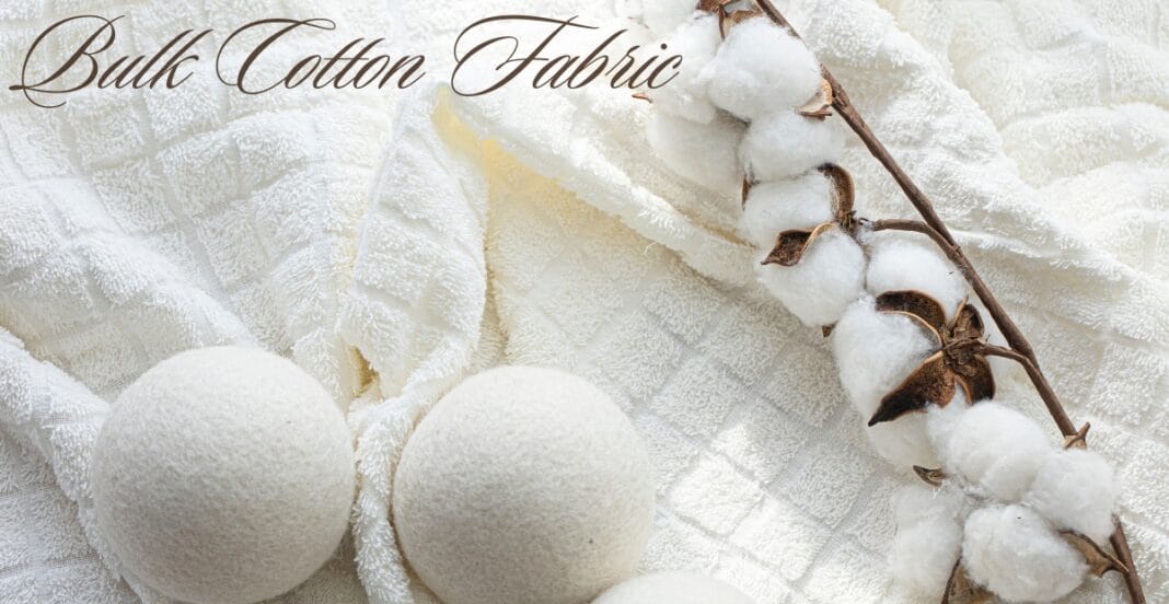 Close-up image of two white cotton balls and a cotton branch with cotton bolls, placed on a textured white fabric background, with the text 
