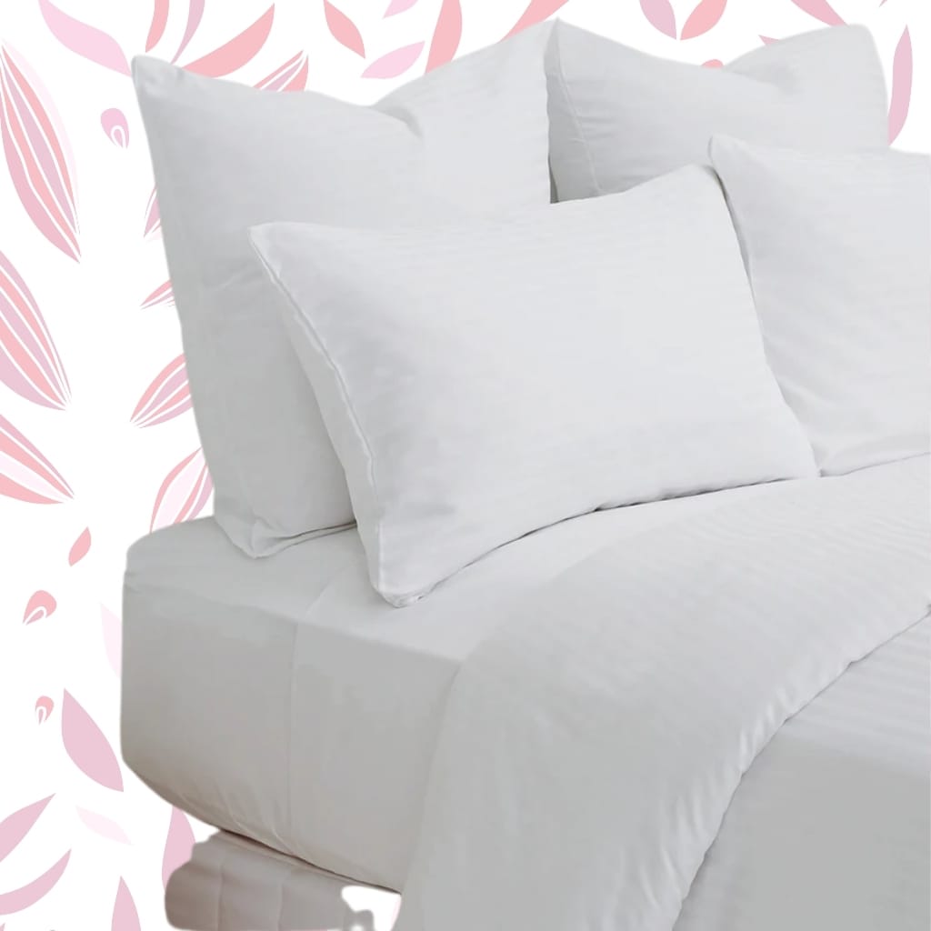 A neatly made bed with white bedding and three white pillows stacked against the headboard, set against a background with a soft pink and white abstract leaf pattern.