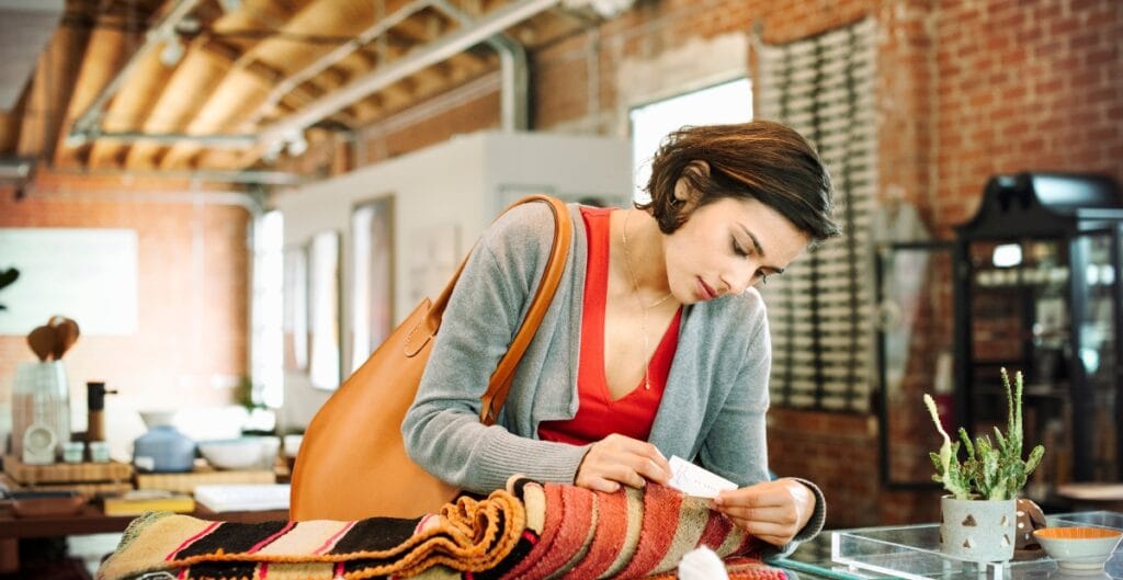 "Customer browsing colorful fabrics in a local sewing shop for smart shopping"
