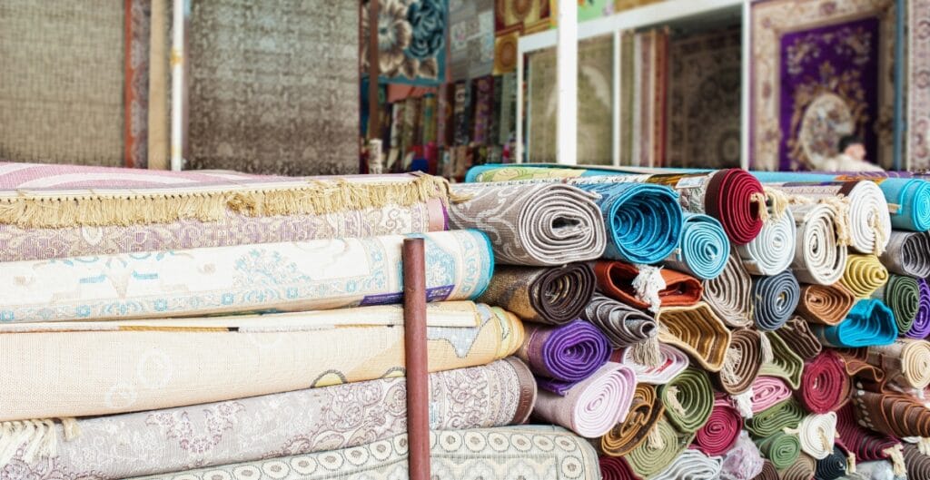 Quilter receiving personalized fabric recommendations and custom quilting services at a local quilt shop.