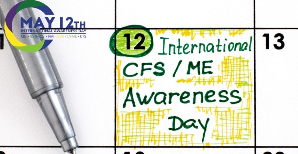 Close-up of a calendar highlighting May 12th with a handwritten note that reads "International CFS/ME Awareness Day," accompanied by a pen.