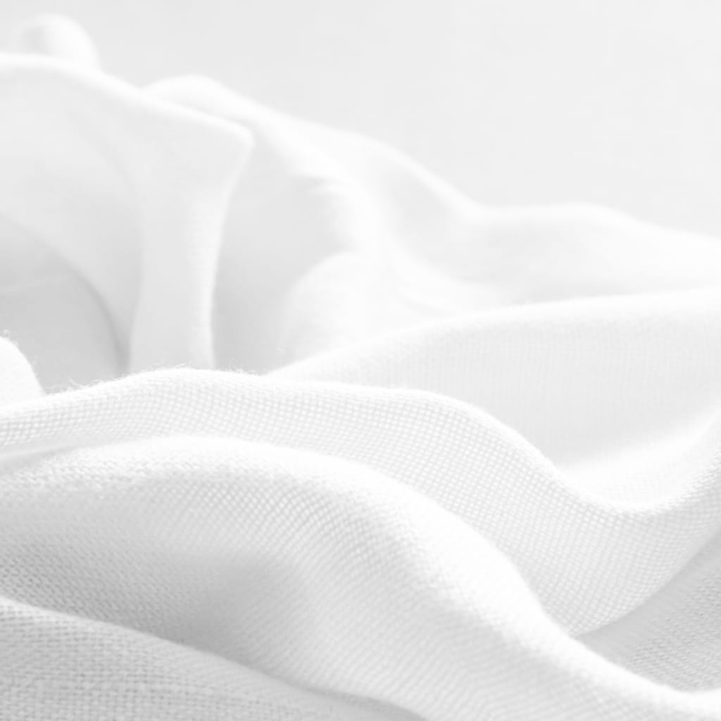 Close-up of soft white linen fabric with gentle folds, showcasing its fine texture and smooth surface.