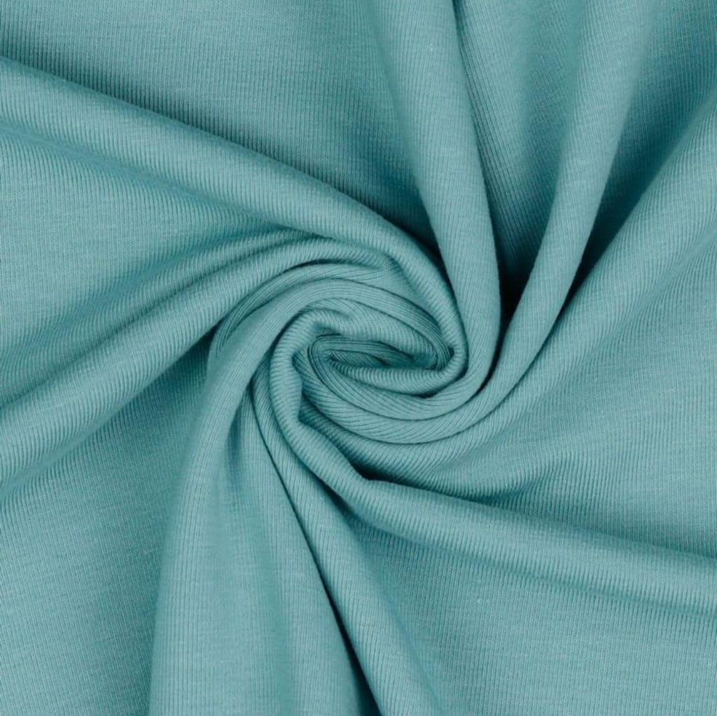 Close-up image of a smooth, light turquoise Jersey cotton fabric with gentle folds and a soft texture.
