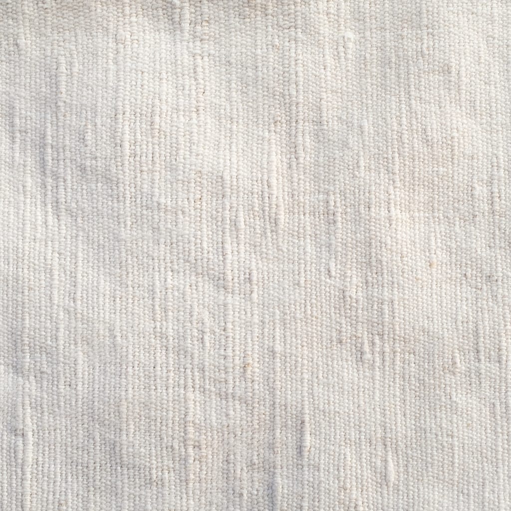 Close-up image of a light-colored, textured fabric surface with a subtle woven pattern.