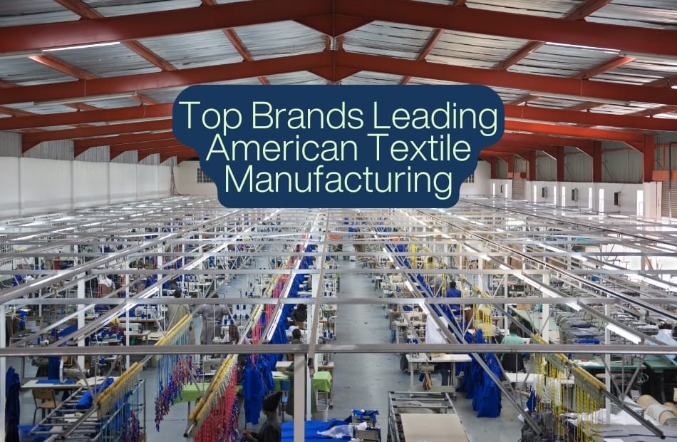 Interior view of a large textile manufacturing factory with rows of sewing stations, workers, and fabric hanging on racks. American Made Textiles