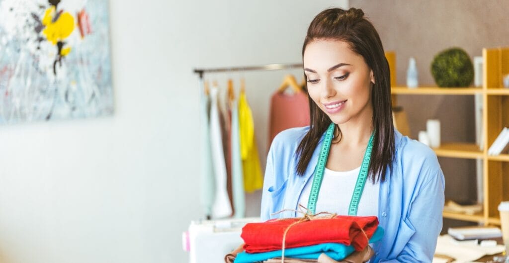 "Customer reading a fabric care label while shopping at a local sewing shop"