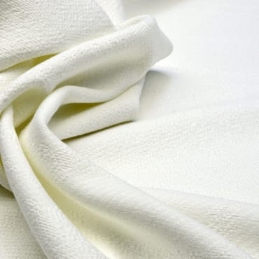 Close-up image of soft, white double-knit polyester fabric with a smooth and textured surface.