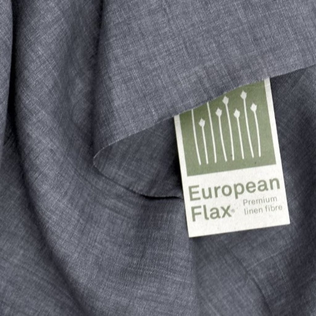 Close-up image of a gray fabric with a tag that reads "European Flax" and "Premium Linen Fibre," featuring a graphic of elongated flax flowers.