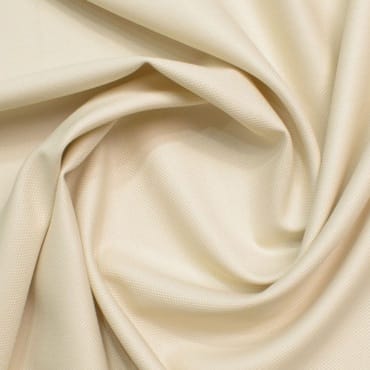 Cream-colored brushed polyester fabric with a smooth, soft texture and gentle folds, suitable for everyday wear.