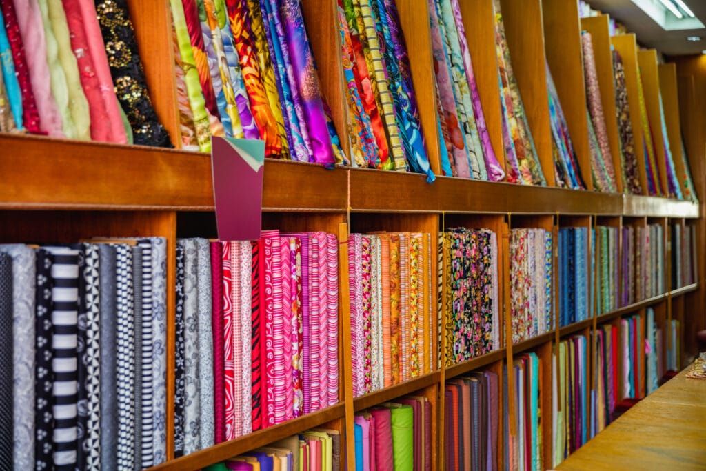 Eco-friendly quilting fabrics and tools displayed at a sustainable quilt shop promoting green practices.