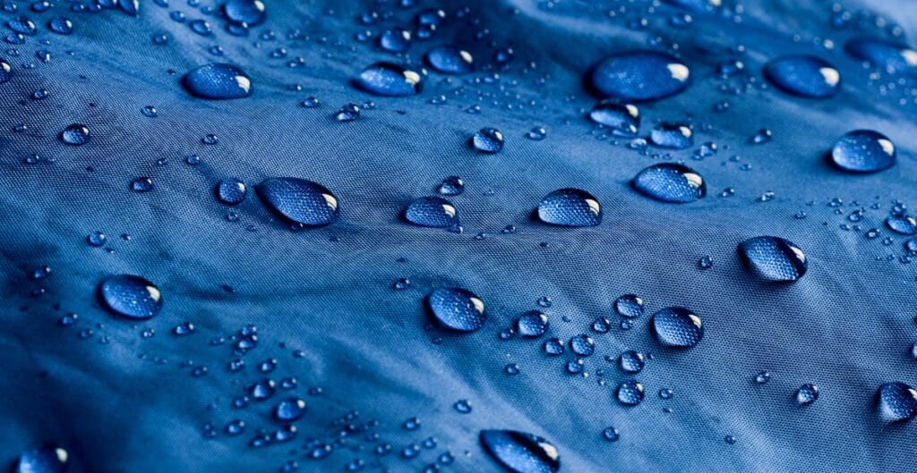 A close-up image of polyester microfiber fabric that is waterproof, showing a smooth, tightly woven surface.