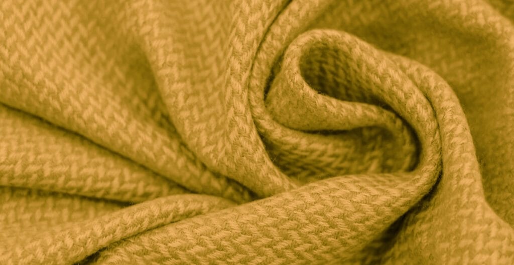 Close-up image of yellow Basket Weave cotton fabric with a textured, interwoven pattern.