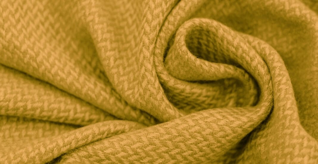 Close-up image of yellow Basket Weave cotton fabric with a textured, interwoven pattern.