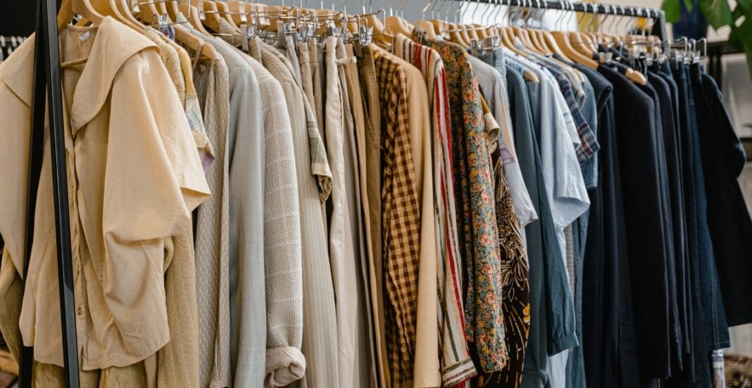 Close-up of a clothing rack with various garments, including a chambray cloth with a soft, textured appearance.