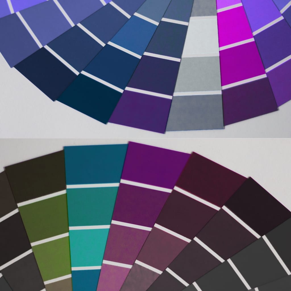 Two sets of color swatches arranged in a semi-circular fan shape, showcasing a diverse palette of designer cotton shades. The upper set features mostly cool purples, blues, and grays, while the lower set includes earth tones, greens, teals, and dark hues.