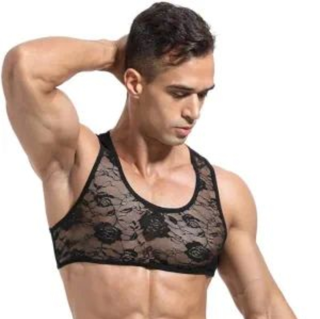 A muscular man wearing a black lace sports bra, with one hand behind his head, showcasing comfort and support.