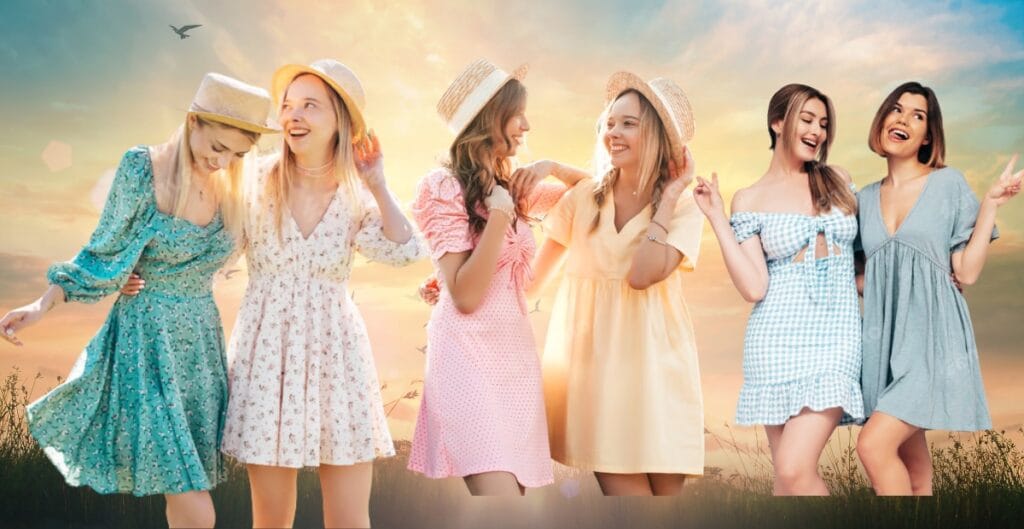 Seven young women in colorful cotton babydoll dresses, smiling and enjoying a fun moment outdoors at sunset.
