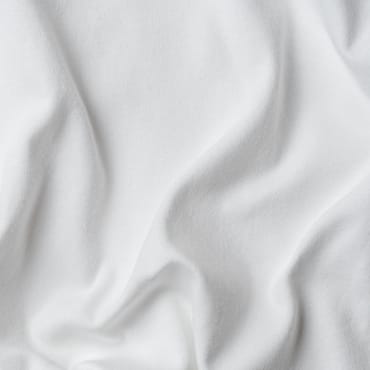 Close-up image of white cotton spandex fabric with soft, slightly wrinkled surface.