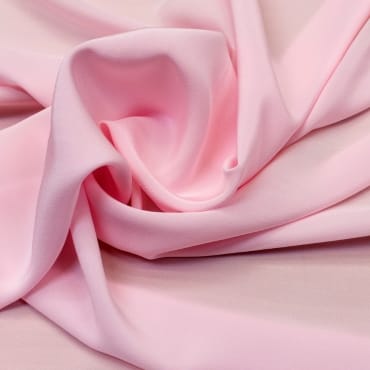 Close-up of crepe chiffon fabric with textured surface and flowing, gathered folds.
