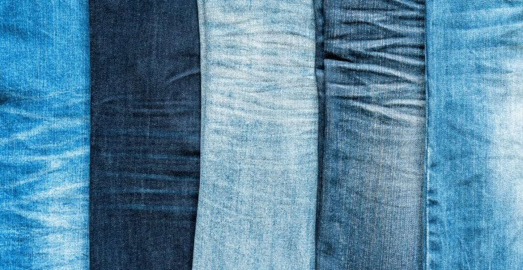 A close-up image displaying five different types of denim fabric, showcasing variations in color and texture.