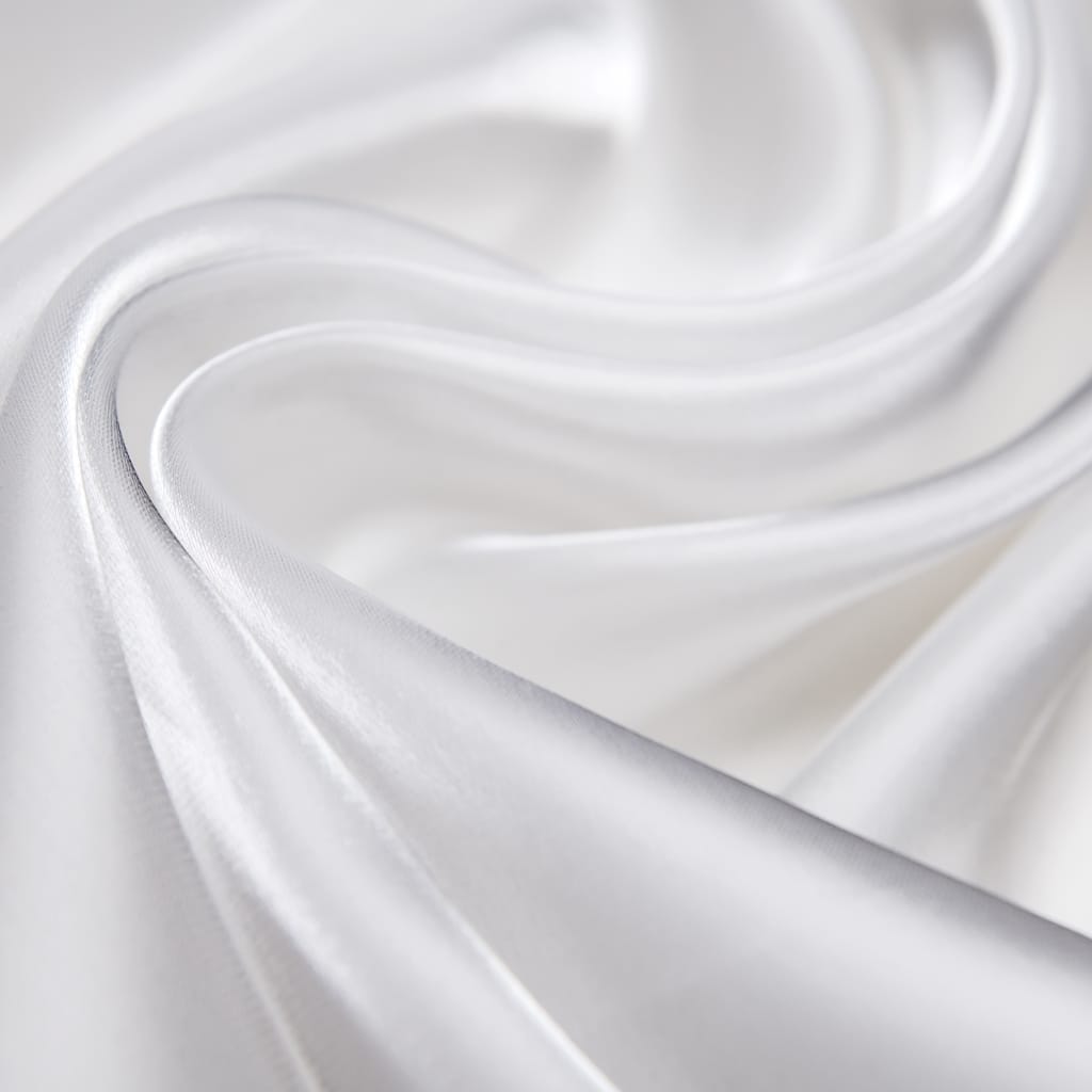 Close-up of smooth, shiny white nylon organza fabric with gentle folds and curves, highlighting its fine, lightweight texture.