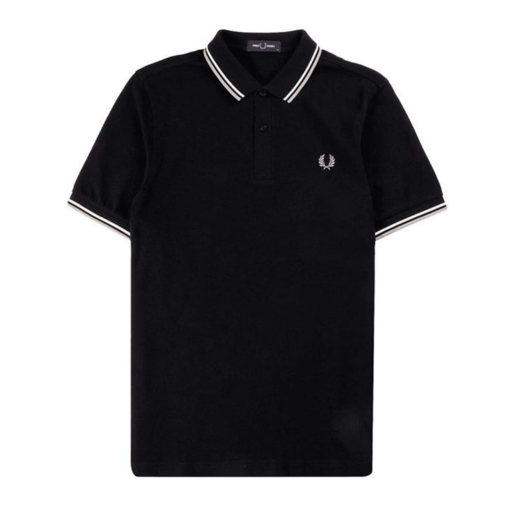 A black Fred Perry polo shirt featuring a classic collar with white stripes and a small embroidered laurel wreath logo on the chest.
