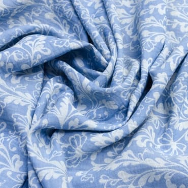 Light blue jacquard chiffon fabric with intricate woven floral and leaf patterns.