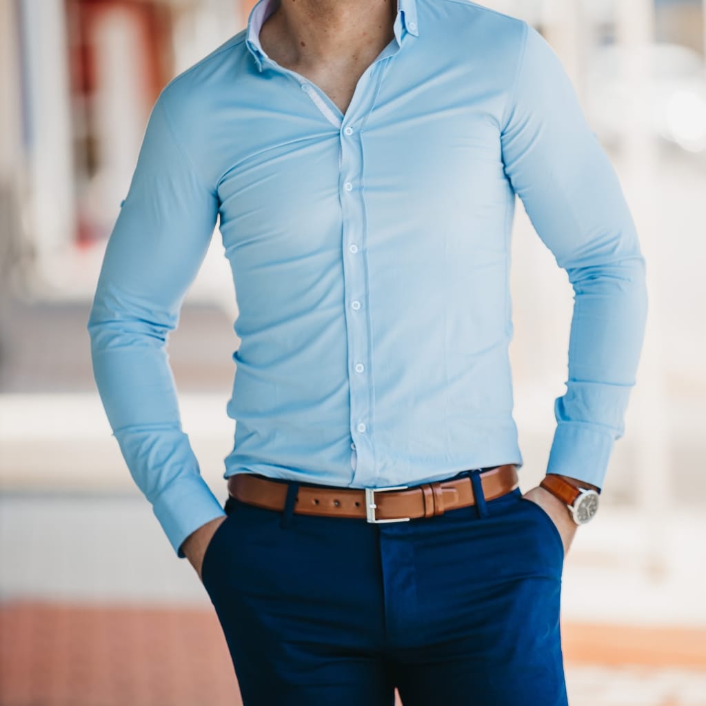 Man wearing a light blue shirt with blue pants in a smart casual outfit