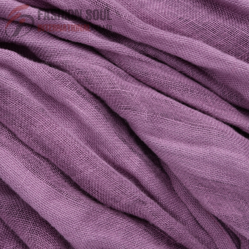 Close-up image of soft purple fabric with a textured, mesh-like pattern and gentle folds.